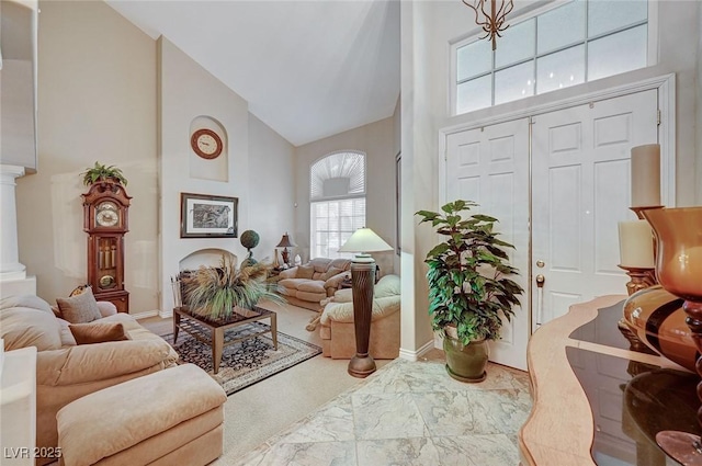 living room with high vaulted ceiling and ornate columns