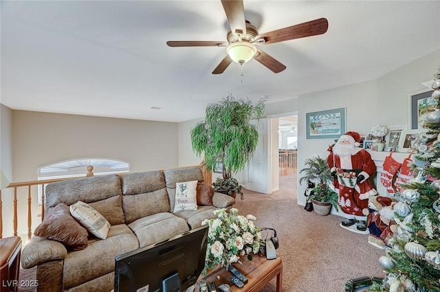 living room featuring carpet flooring, ceiling fan, and a wealth of natural light