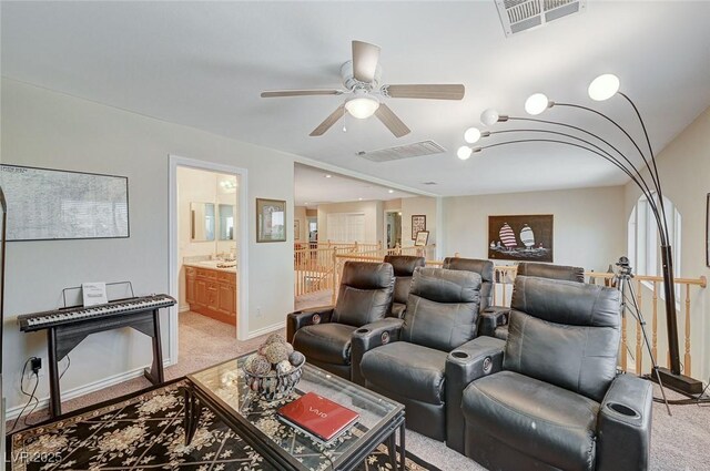 home theater featuring light carpet and ceiling fan