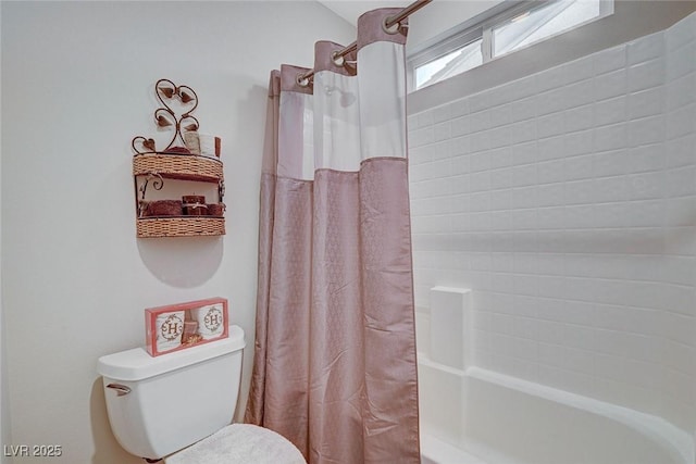 bathroom with curtained shower and toilet