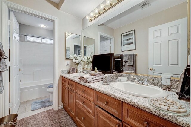 full bathroom featuring tile patterned flooring, bathtub / shower combination, vanity, and toilet