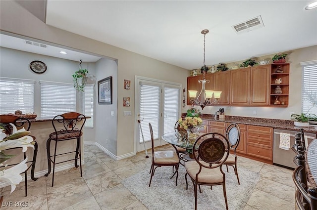 dining space with a wealth of natural light and a notable chandelier