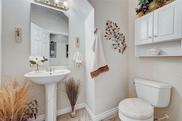 bathroom featuring tile patterned floors, sink, and toilet