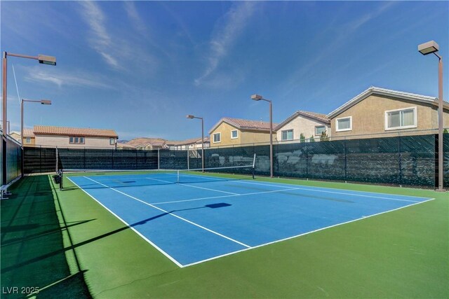 view of tennis court with basketball hoop