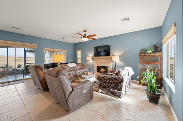 living room with light tile patterned floors and ceiling fan