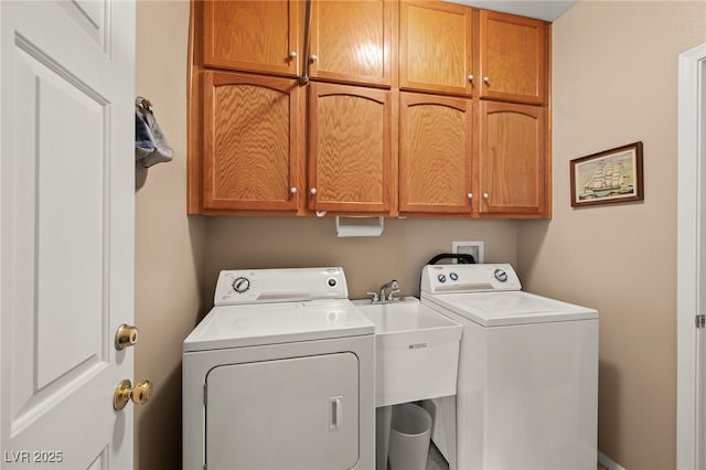 laundry room with cabinets and washing machine and dryer