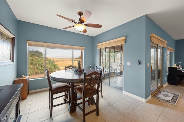 dining area featuring ceiling fan and light tile patterned flooring