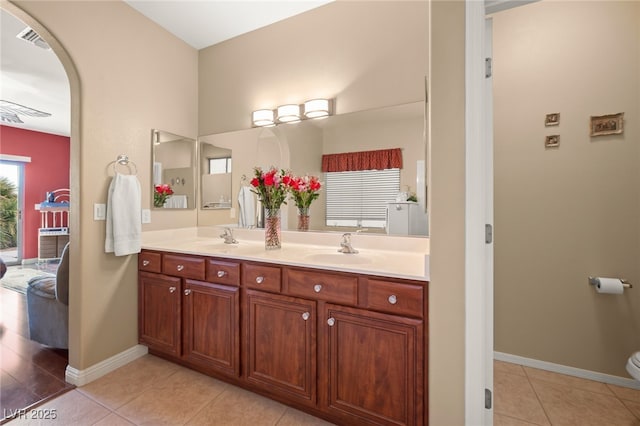 bathroom with tile patterned flooring, vanity, and toilet