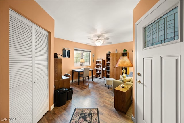 interior space with wood-type flooring and ceiling fan