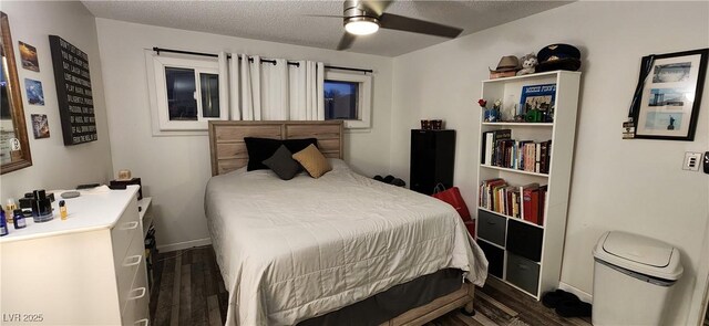 bedroom with a textured ceiling, dark hardwood / wood-style flooring, and ceiling fan