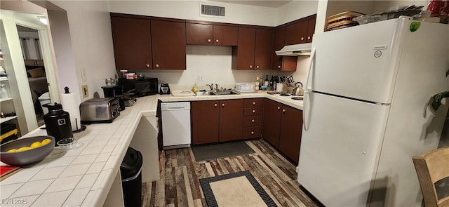 kitchen featuring dark brown cabinets, white appliances, and sink