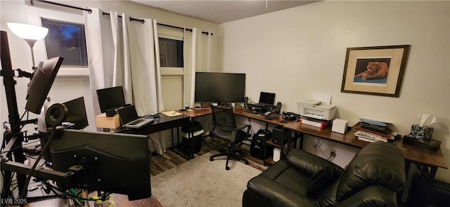 office space with light hardwood / wood-style floors and a textured ceiling