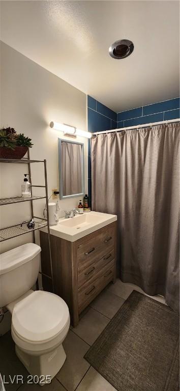 bathroom featuring tile patterned flooring, toilet, vanity, and a shower with shower curtain