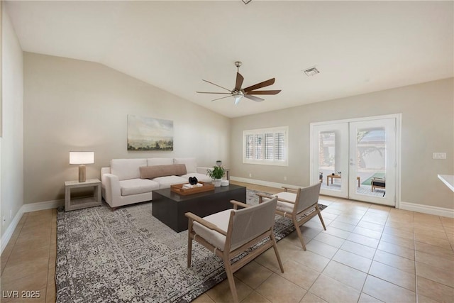 tiled living room with french doors, ceiling fan, and vaulted ceiling