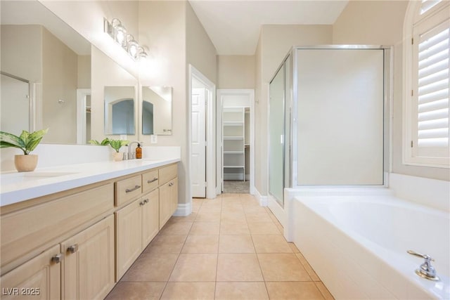 bathroom with shower with separate bathtub, tile patterned floors, and vanity