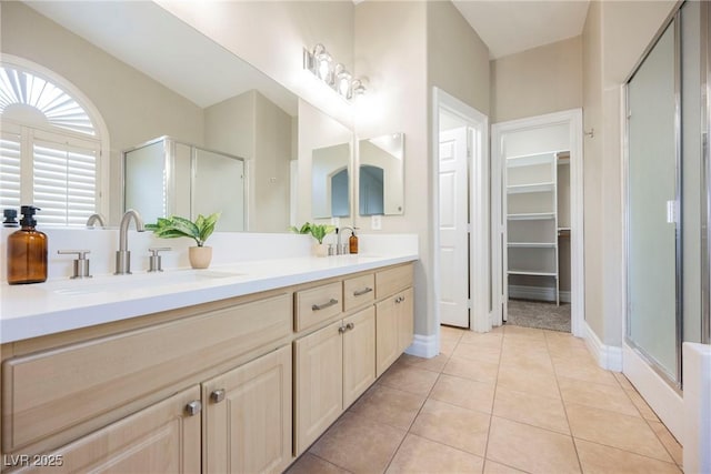 bathroom featuring vanity, tile patterned floors, and a shower with door