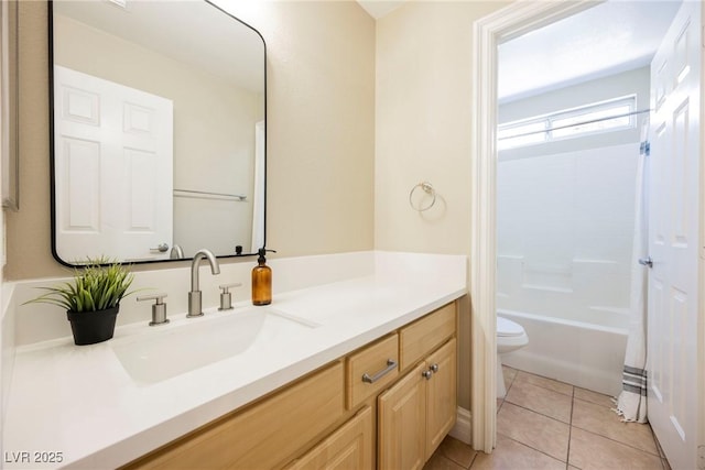 full bathroom with tile patterned floors, toilet,  shower combination, and vanity