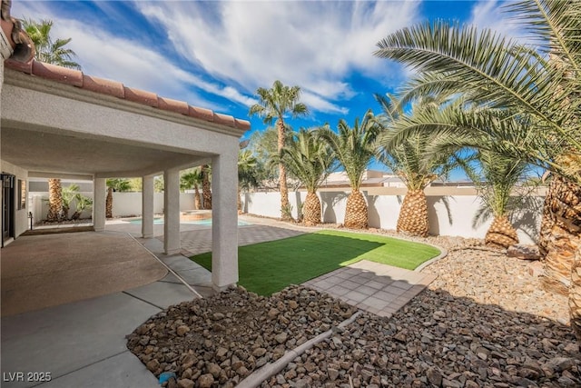 view of yard featuring a fenced in pool and a patio