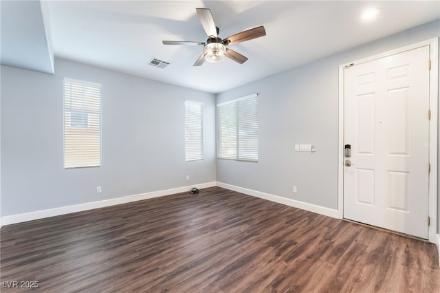 empty room with dark hardwood / wood-style flooring and ceiling fan