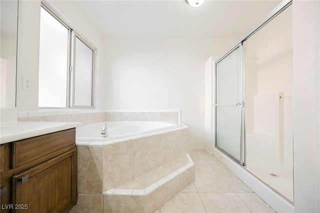 bathroom featuring tile patterned flooring, shower with separate bathtub, and vanity