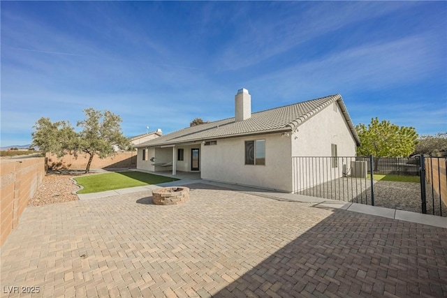 back of house with a patio and an outdoor fire pit