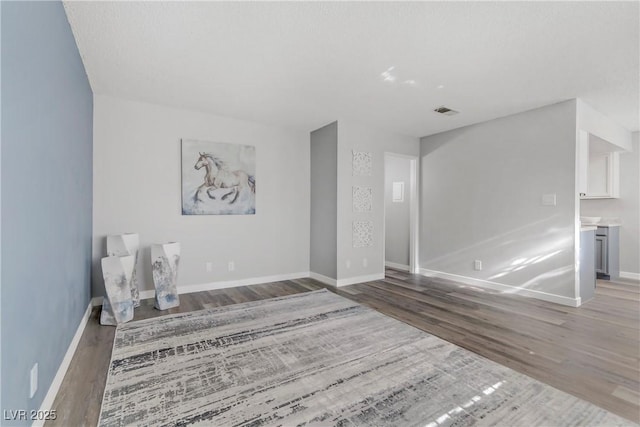 interior space featuring visible vents, baseboards, and wood finished floors