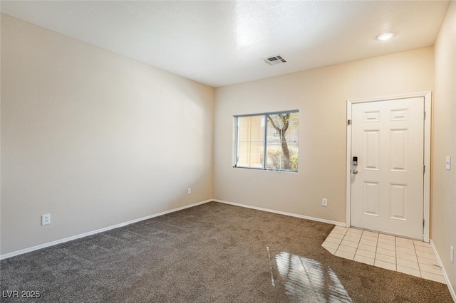 foyer entrance featuring carpet