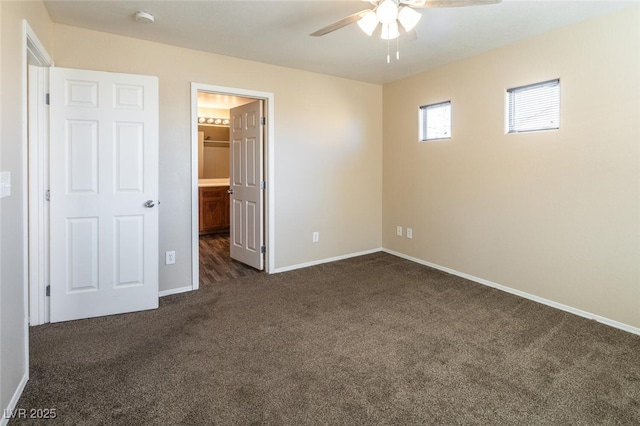 unfurnished bedroom with ceiling fan and dark carpet