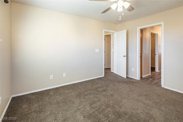 unfurnished bedroom with ceiling fan and dark carpet