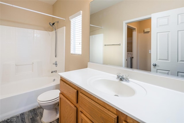 full bathroom with shower / bathing tub combination, hardwood / wood-style floors, vanity, and toilet