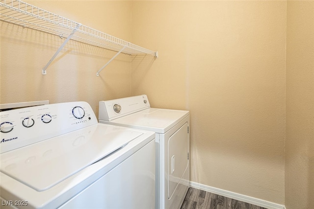 washroom featuring washer and dryer and dark hardwood / wood-style floors