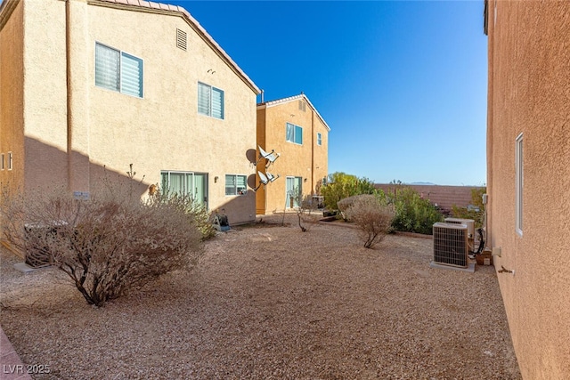 rear view of property with central AC unit