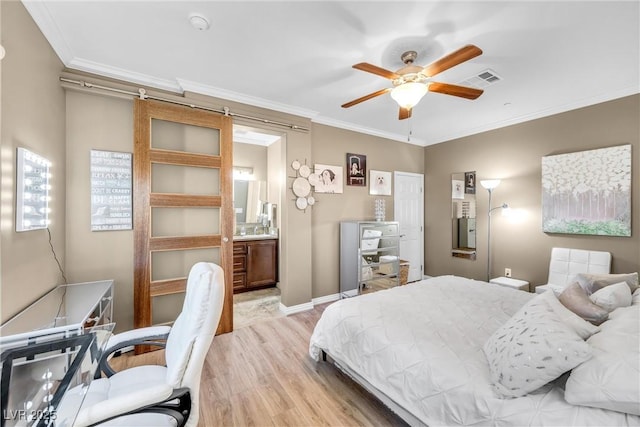 bedroom featuring ceiling fan, ensuite bathroom, crown molding, and light hardwood / wood-style floors