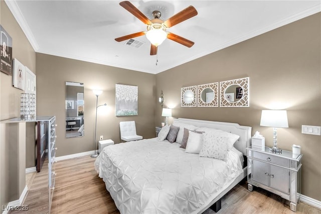 bedroom featuring ceiling fan, light hardwood / wood-style floors, and ornamental molding