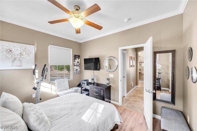 bedroom with a ceiling fan, crown molding, light wood-style floors, and baseboards