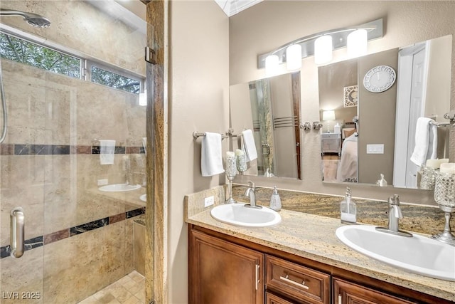 full bath featuring ensuite bath, a stall shower, and a sink