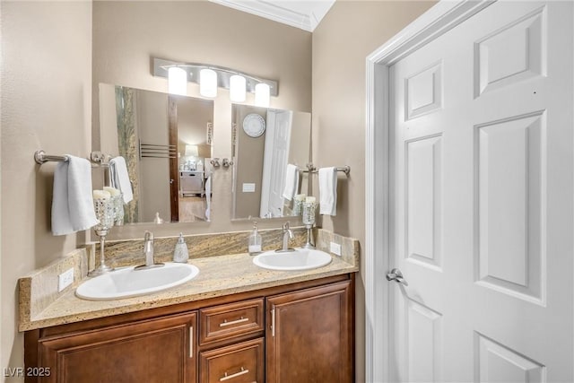full bath featuring a sink, double vanity, and crown molding