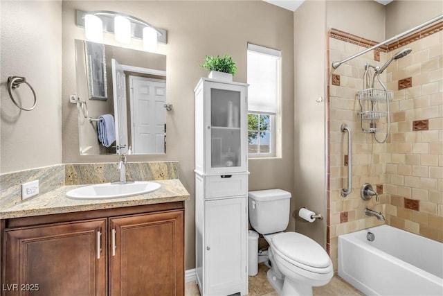 full bathroom featuring tiled shower / bath combo, vanity, and toilet