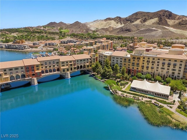 birds eye view of property with a water and mountain view