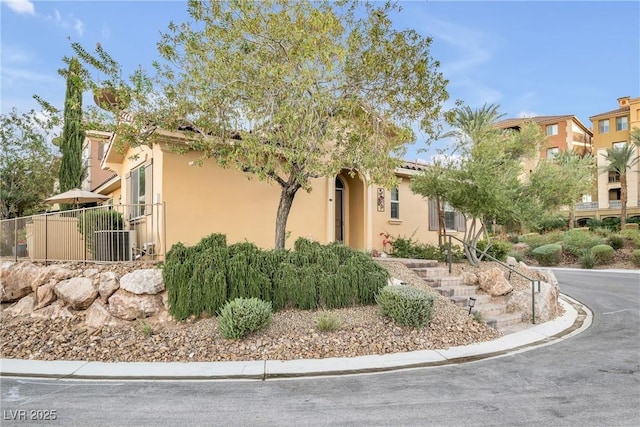 exterior space featuring fence and stucco siding