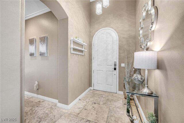 entryway with arched walkways and baseboards