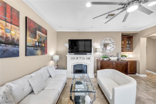 living room with visible vents, baseboards, crown molding, and a ceiling fan
