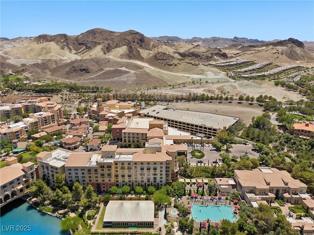 drone / aerial view with a water and mountain view