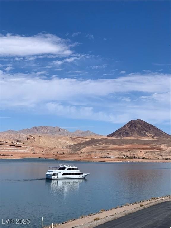 view of water feature with a dock and a mountain view