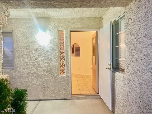 corridor with light tile patterned flooring