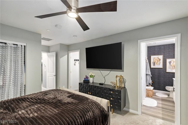 bedroom featuring ceiling fan, light carpet, and connected bathroom