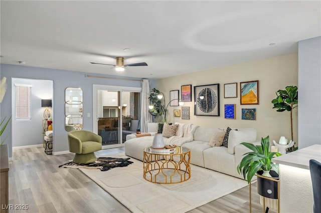 living room featuring light hardwood / wood-style flooring and ceiling fan