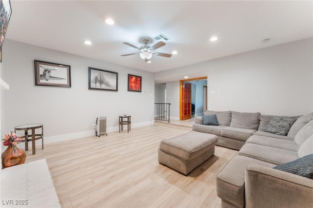 living room with ceiling fan and light wood-type flooring