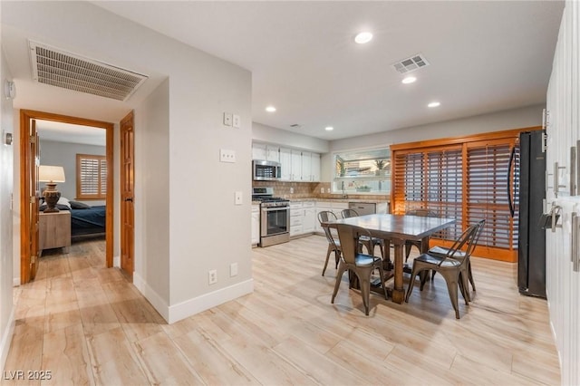 dining space featuring light wood-type flooring