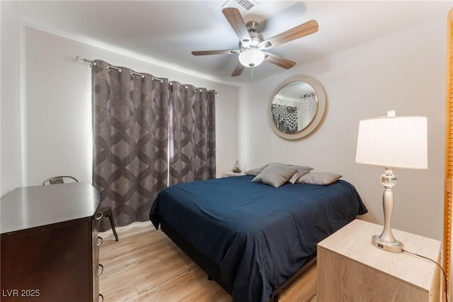 bedroom with ceiling fan and light hardwood / wood-style floors